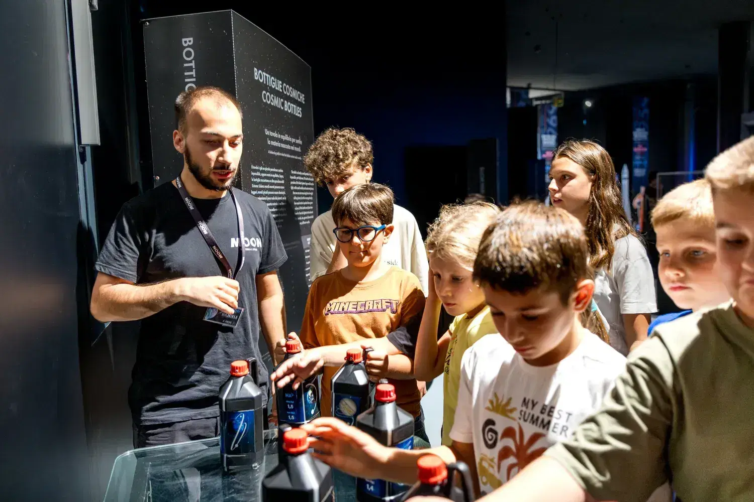 An operator shows an experiment to a group of children